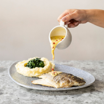 fresh filleted sea bream, pan-seared with garlic, butter, Mediterranean herbs, capers, lemon-zest & served with potato mash and creamted spinach.